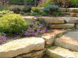 Close up view of hardscape planters incorporated into the design of this landscaped hillside.